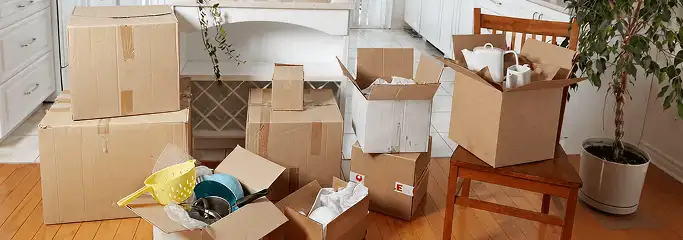 Packed moving boxes and household items in a kitchen before move-out or move-in cleaning, Honolulu, HI.